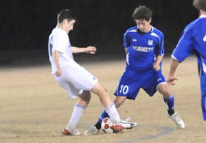 Alex Rowlan (10) vies for control with a Catholic player.