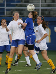 Shelby Bryant heads the ball as she battles against a pair of North Little Rock players during a 2008 game.