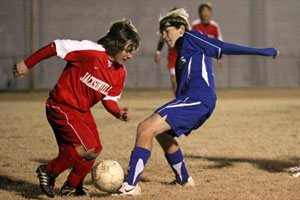 Bryant's Jonathan Lowery, right, battles a Jacksonville player for possession.