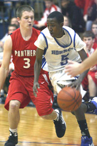 Bryant point guard K-Ron Lairy (5) drives around Cabot's Seth Bloomberg.