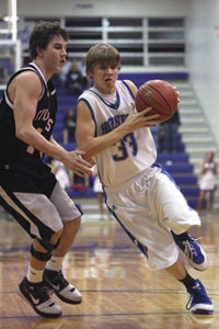 Connor Rayburn drives into the lane against Russellville's Branden Turner.