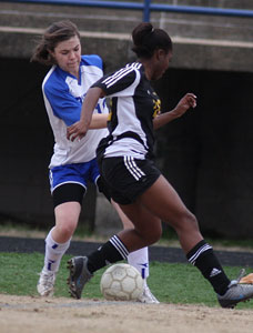 Erica Selig, left, battles for possession during a game against Little Rock Central last season.