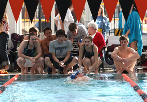 Members of the Bryant High School swim team cheer on teammate Jordan Martin in the 500 yard freestyle at a recent meet at Hendrix.