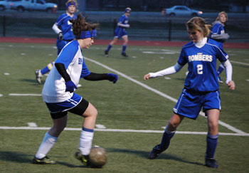 Bryant's Erica Selig, left, works to get around a Mountain Home defender.