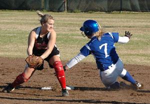 Senior Christen Kirchner (7) slides wide to avoid a play at second on a stolen base.