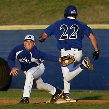 Bryant's Brady Butler stretches for a throw as Conway's Patrick Dunn reaches first on a bang-bang play that went Bryant's way.