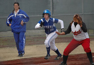 Bryant coach Lisa Stanfield looks on as Kayla Sory makes a break off third. (Photo by Mark Hart)