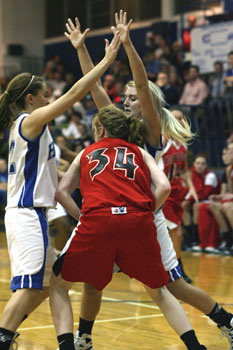 Taylor Hughes, left, and Anna Simpson trap a Russellville player during a game earlier this season.