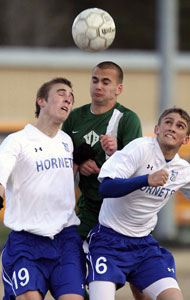 Tyler Salminen, 19, and Aaron Prewitt, 6, battle head-to-head-to-head with a Van Buren player for control.