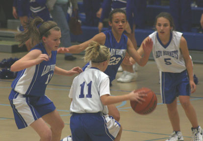 Logan Davis, left, and McKenzie Adams apply defensive pressure against Bethel's Megan Archibald, 11, and Carley Staggs, 5.