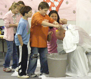 Salem Elementary Principal Mark Scarlett gets an egg shampoo from the students during the Jump Rope for Heart Assembly.