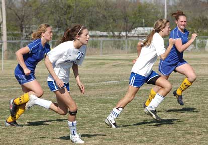 Lindsei Arceneaux and Amber Moskow sprint upfield shadowed by a pair of North Little Rock defenders during Saturday's championship game in Jonesboro. (Photo by Mark Hart)