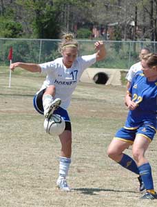Tarra Hendricks (17) tries to knock down a pass. (Photo by Mark Hart)