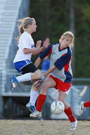 Madison Land collides with the Cabot keeper during Tuesday's 7A-Central Conference game. (Photo by Misty Platt)