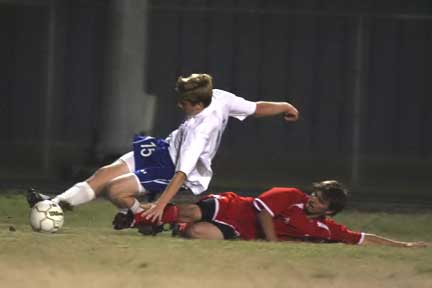 Bryant's Kyle Nossaman hits the ground after being tripped up by a Cabot player during Tuesday's match (Photo by Rick Nation)