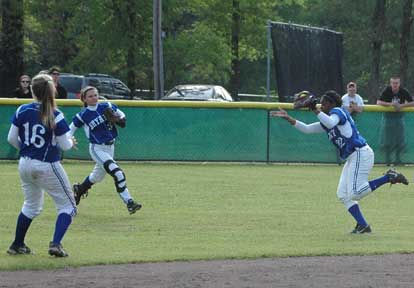 Shanika Johnson tracks down a pop in shallow center and teammates Paige Turpin and Kayla Sory converge on the play. (Photo by Mark Hart)