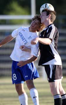 Pete Alverio, left, and a Central player try to get a head on the ball. (Photo by Misty Platt)
