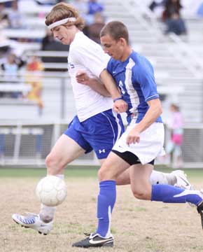 Bryant's Tim Ezel, left, battles for control. (Photo by Misty Platt)