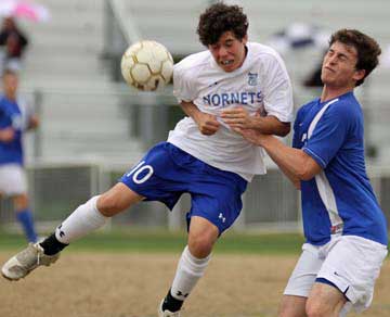 Alex Rowlan cuts in front of a Conway defender for a header. (Photo by Misty Platt)