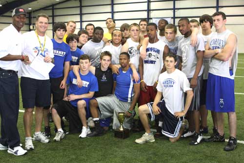 Bryant head football coach Paul Calley accepts the $1000 donation after this group of Hornets out-performed a contingent of Benton players in a scouting combine-styled event at D1 Sports Training in Little Rock.