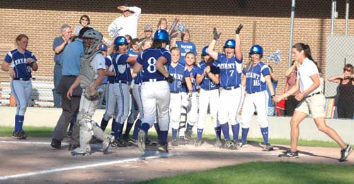 Jessie Taylor (8) is greeted by her teammates after he game-turning grand slam at North Little Rock. (Photo by Mark Hart)