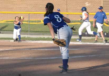 Kayla Sory, left, takes a throw at first from Jessie Taylor at third to retire a North Little Rock batter. (Photo by Mark Hart)