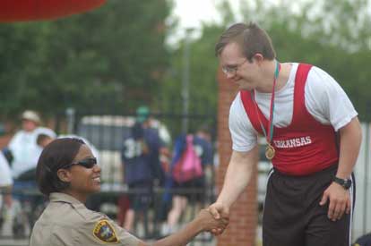 Joshua Garland is congratulated after receiving one his gold medals at the Special Olympics.