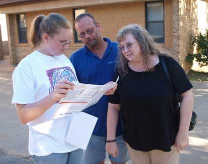 A freshman student and her parents study a map of the Bryant High School campus. (Photo by Lana Clifton)