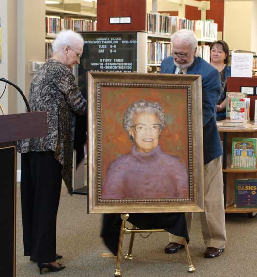 Valine Meyer and Ted Boswell unveil the portrait of their mother Mabel Boswell. (Photo by Lana Clifton)