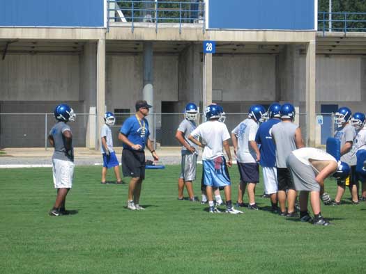 Bryant head coach Paul Calley instructs the offense during Tuesday's practice.