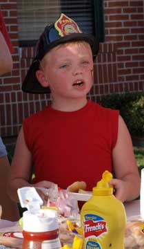 Connor McNeil enjoys a hot dog. (Photo by Lana Clifton)