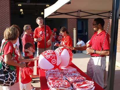 Target volunteers, Jessica Alvarado and Jason Deslandes help distribute beach balls. (Photo by Lana Clifton)