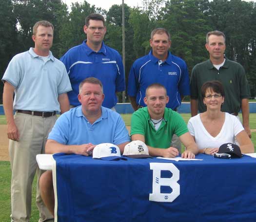 Justin Blankenship, flanked by his parents Mark and Robin, signs a letter of intent to continue his baseball career and education at the University of Arkansas-Fort Smith, as coaches, from left, Tic Harrison, Frank Fisher, Kirk Bock and Craig Harrison look on.