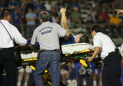 Collin Chapdelaine gives a thumbs-up as he's carted from the field. (Photo by Rick Nation)