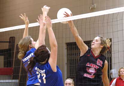 Peyton Thacker and Sydney Manley attempt a block in the Bryant JV contest Tuesday. (Photo by Mark Hart)