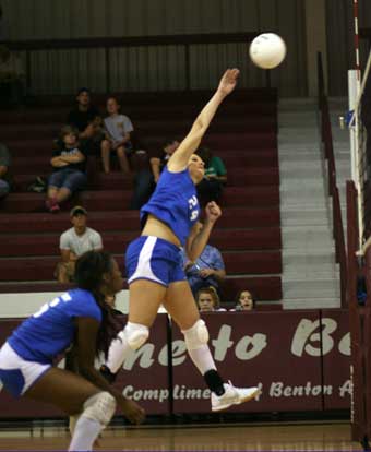 Taylor Shutt (24) spikes the ball in front of teammate Brianna White. (Photo by Rick Nation)