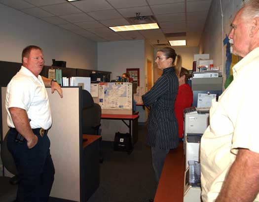 Sgt. Jenceson Payte quietly discusses what happens in the 911/dispatch room of the Bryant Police Department.  When a 911 call came in, Payte and the CPA group quietly left the office. (Photo by Lana Clifton)