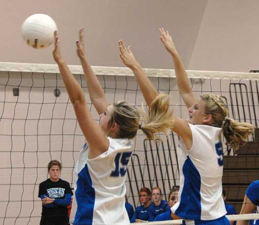 Jenna Bruick and Maggie Hart go up for a block at the net. (Photo by Mark Hart)