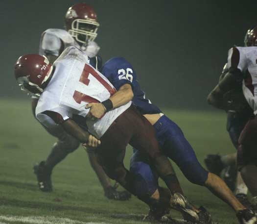 Bryant's Brennan Bullock (26) smacks down Texarkana punt returner Domenique Brown during last week's game. (Photo by Rick Nation)