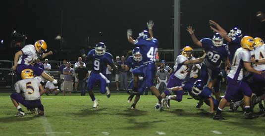 Hornets Sammill Watson (9), Dylan Blasi (40), Josh Hampton (98) and Hunter Mayall (18) pressure the field goal attempt of Chris Ashburn that Mayall wound up blocking to preserve Bryant's lead. (Photo by Rick Nation)