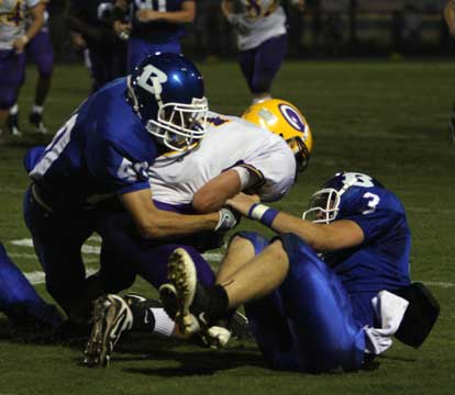 Bryant's Dylan Blasi (40) and Brady Butler (3) bring down Catholic's Bonner Chilton (5). (Photo by Rick Nation)