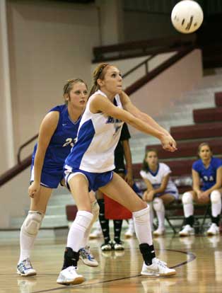 Morgan Crider returns serve in front of teammate Brianna Hays. (Photo by Rick Nation)