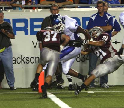 Benton's Zach Davis (37) and Greg Pryor (21) try to keep Bryant's Marcus Harris (33) out of the end zone to no avail. (Photo by Rick Nation)