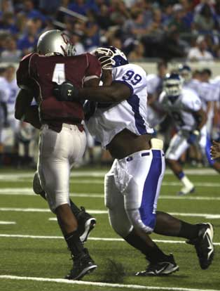 Bryant defensive tackle Ronnie Maxwell (99) drops Benton's Tammario Beaugard for a loss. (Photo by Rick Nation)