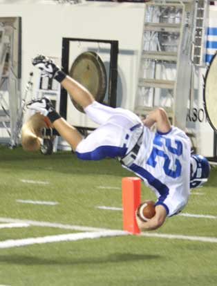Jacob Powell tumbles into the end zone after hurdling a Benton defender. (Photo by Rick Nation)