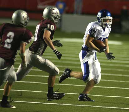 Bryant's Jon Reed (47) tries to avoid Benton's Madison Dixon (10) and Connor Calaway (2) after hauling in a swing pass. (Photo by Rick Nation)