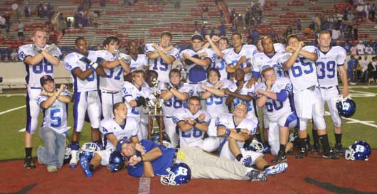 The Bryant seniors celebrate their third Salt Bowl victory with head coach Paul Calley. (Photo by Rick Nation)