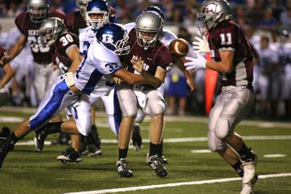 Bryant linebacker Trey Sowell (37) clobbers Benton quarterback Grant Jones as he pitched to Drew McCurry (11). (Photo by Rick Nation)