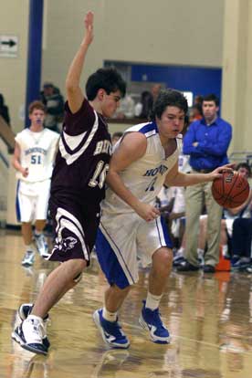 Bryant's Zach Cambron tries to drive around Benton's Blaze Magana. (Photo by Rick Nation)