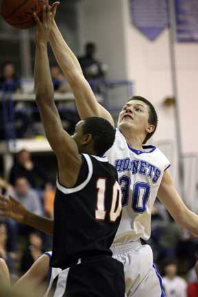 L.J. McLaughlin blocks a shot by Russellville's Parnell Webb. (Photo by Rick Nation)